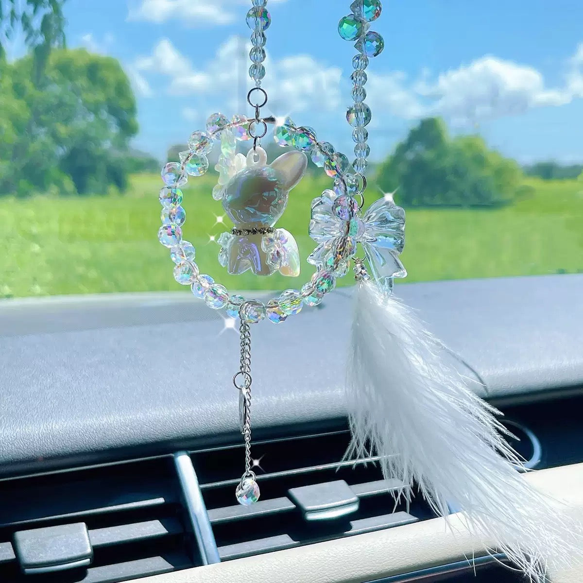 A cute car hanging decoration with a deer, a flower and feathers. It's a lovely rearview mirror car accessory for goddesses.