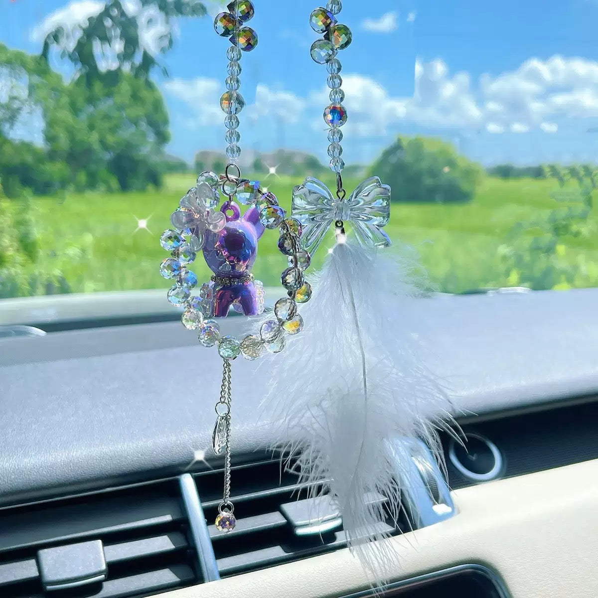 A cute car hanging decoration with a deer, a flower and feathers. It's a lovely rearview mirror car accessory for goddesses.