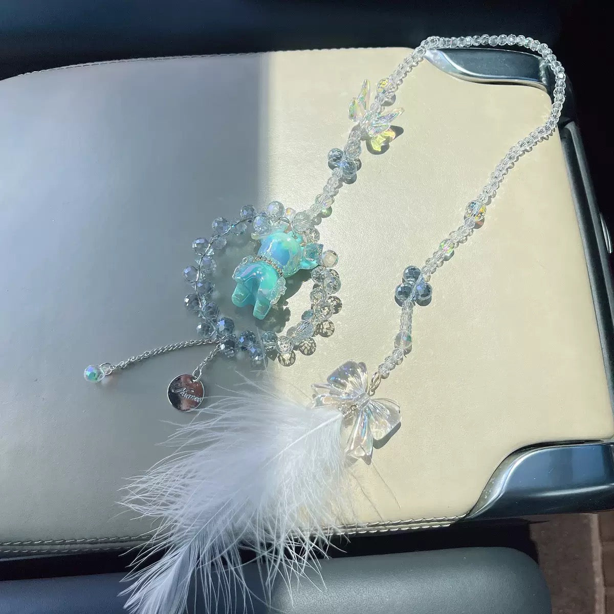A cute car hanging decoration with a deer, a flower and feathers. It's a lovely rearview mirror car accessory for goddesses.